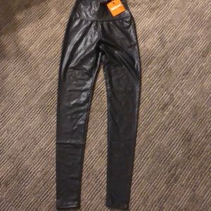 Shiny leather look spandex.  High waisted